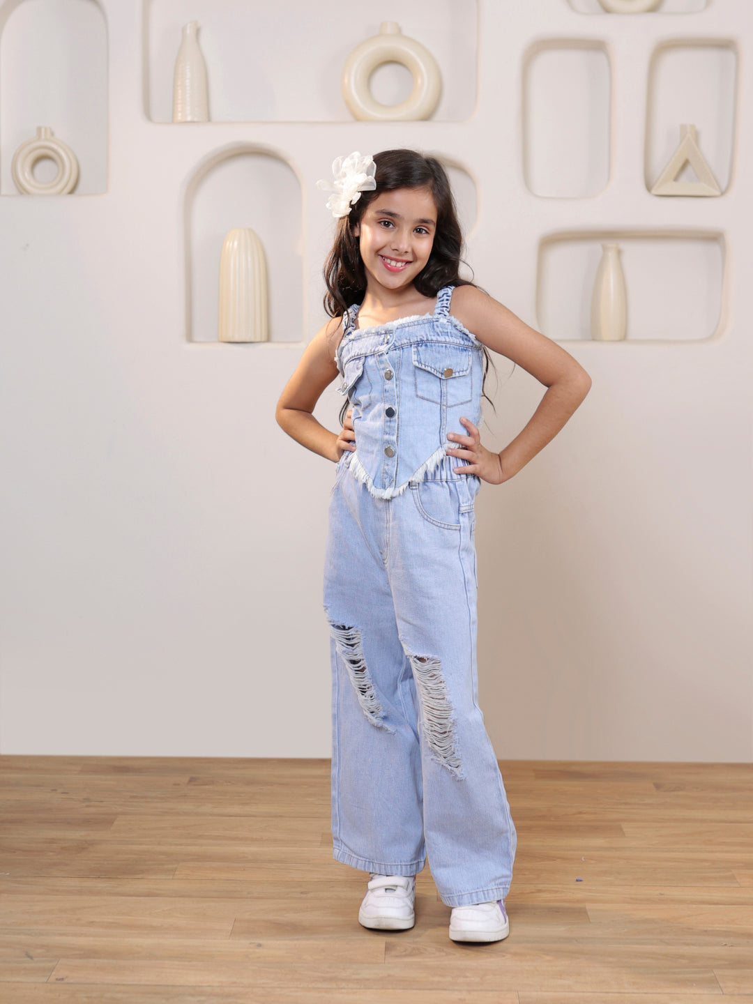 Sleeveless solid denim vest and ripped denim pants