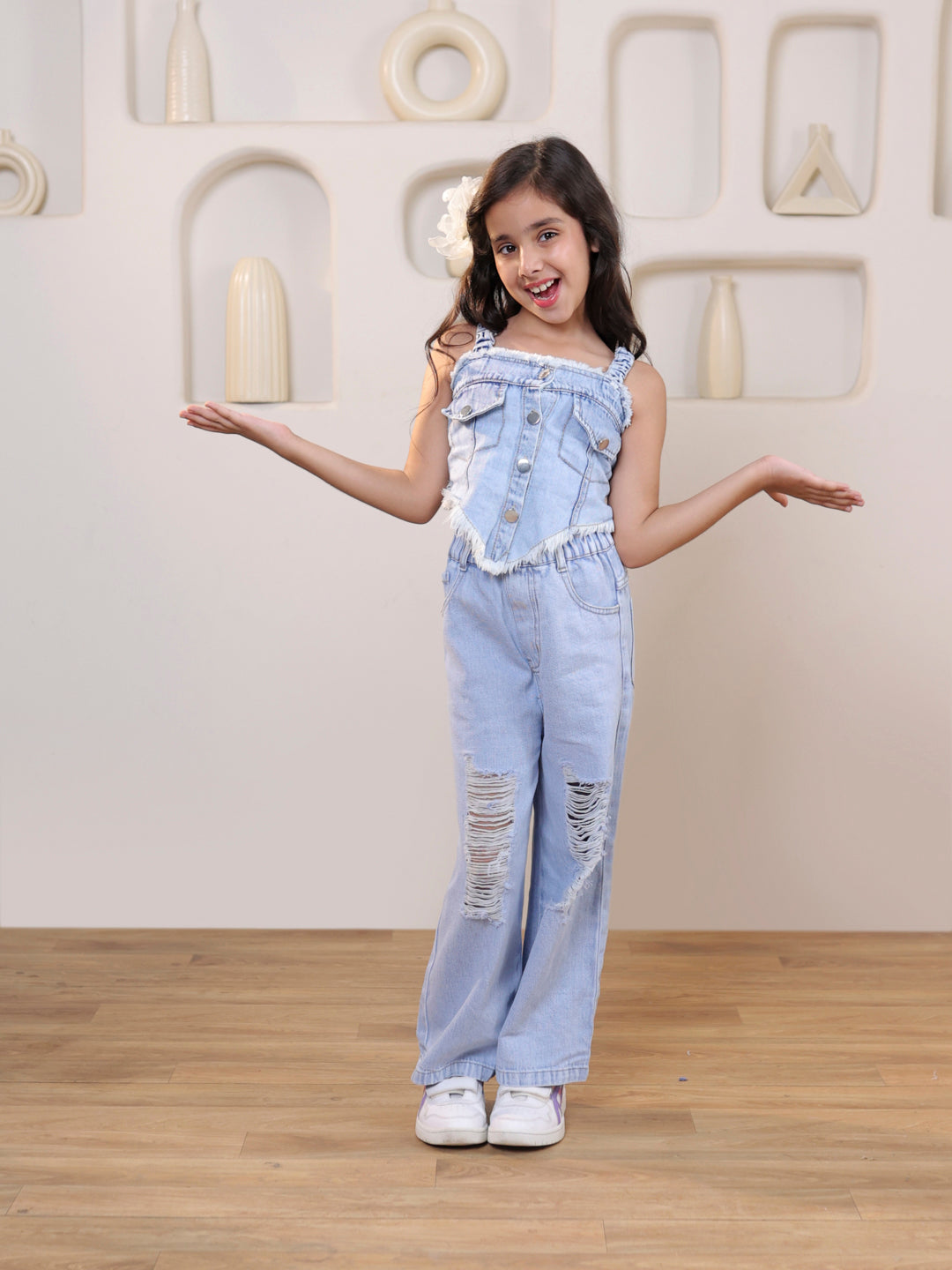 Sleeveless solid denim vest and ripped denim pants