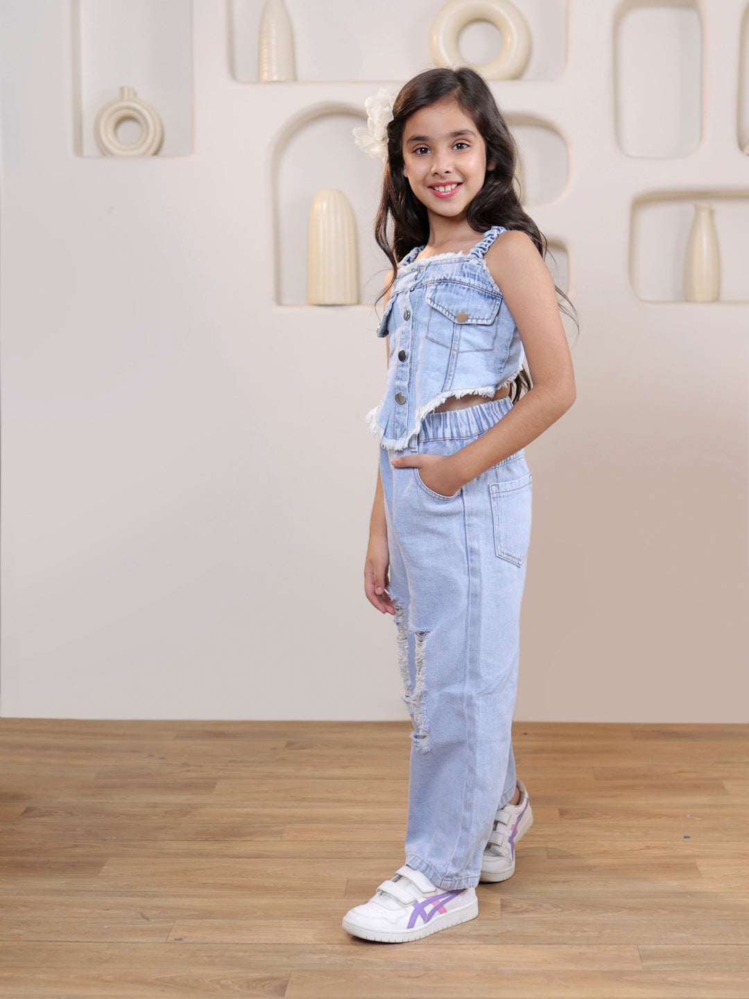 Sleeveless solid denim vest and ripped denim pants