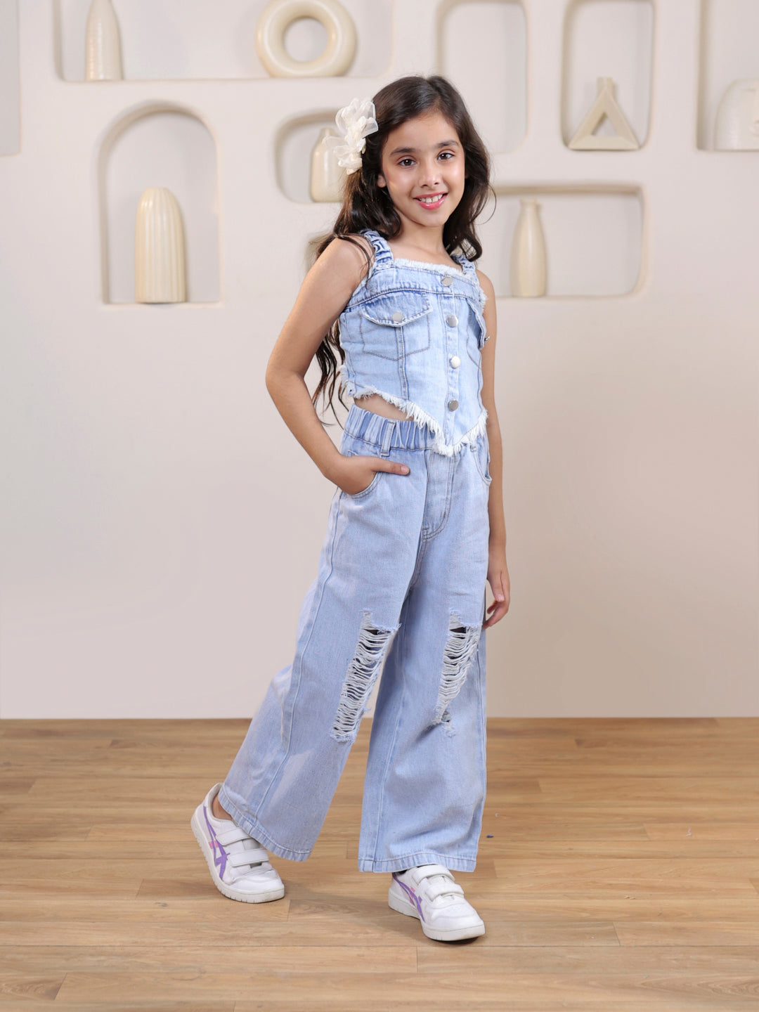 Sleeveless solid denim vest and ripped denim pants