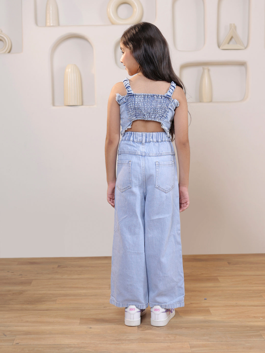 Sleeveless solid denim vest and ripped denim pants