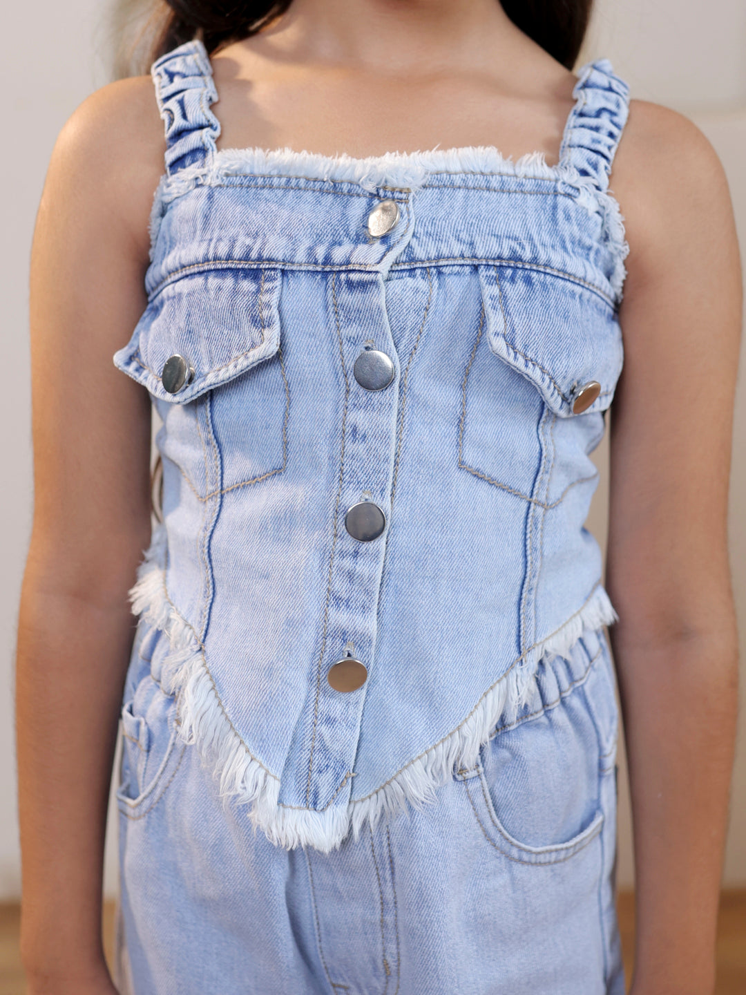 Sleeveless solid denim vest and ripped denim pants
